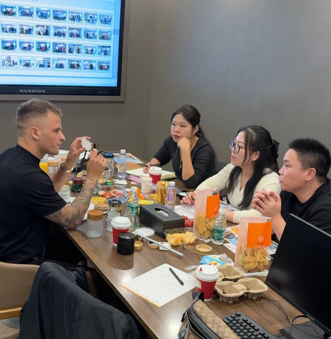 A group of people sitting around a table eating food.