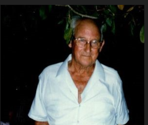 A man in a white shirt and khaki pants.