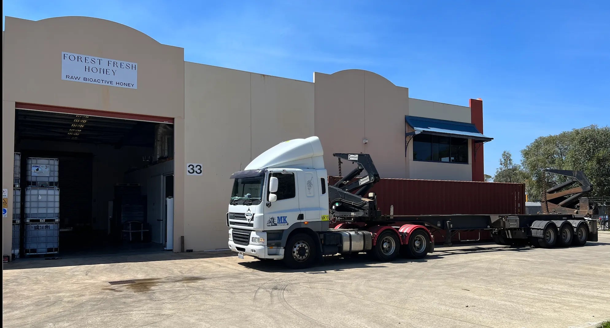 A semi truck parked in front of a building.