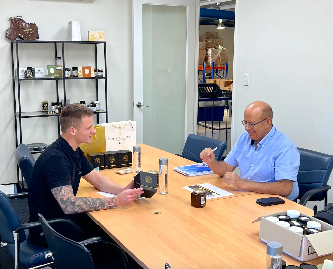 A man sitting at a table with another man.