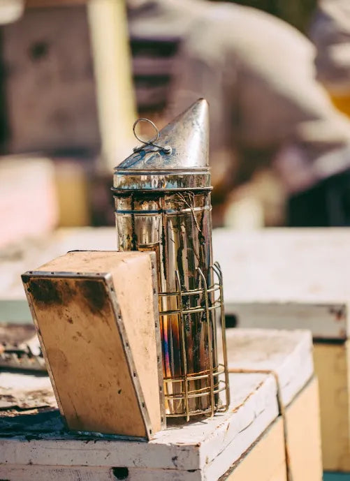A metal object sitting on top of a wooden box.